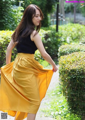 A woman laying on the floor with her hair blowing in the wind.