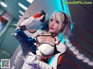 A woman in a white and black outfit holding a blue gun.