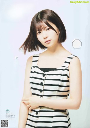 A woman in a black shirt is posing for a magazine.