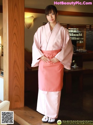 A woman in a white bra and panties posing for the camera.