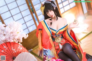 A woman in a kimono with a mask on her head.