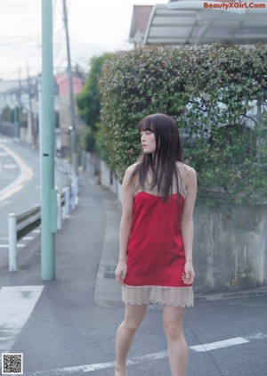 A woman with long black hair is posing for the camera.