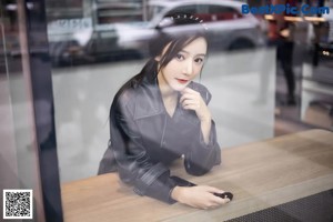 a woman sitting on top of a chair in a room