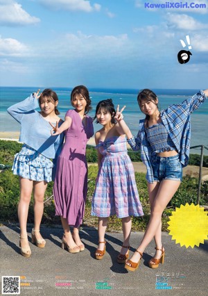 A couple of women standing next to each other on a beach.