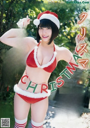 A woman in a santa hat is posing for a magazine cover.