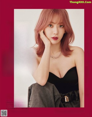 A magazine with a picture of a woman in a red dress.