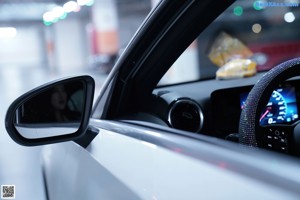 A woman sitting in the back seat of a car.