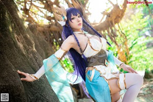 A woman dressed in a cosplay outfit posing for a picture.