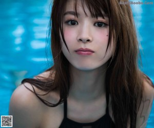 A woman in a blue and white bikini posing for a picture.