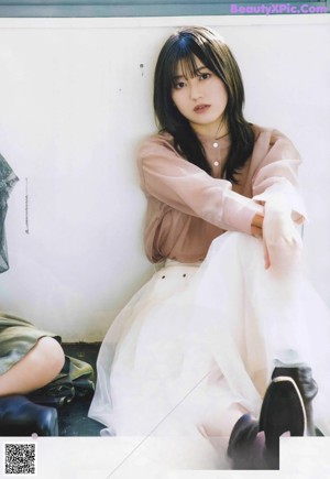 A magazine spread with a picture of a woman talking on a cell phone.
