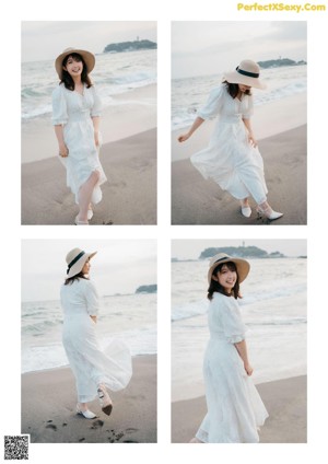 A woman in a white dress sitting on the beach.